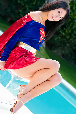 Catie Minx flashes her pussy posing in a Superwoman costume by the pool