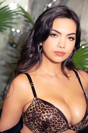 Emily Kaye in leopard lingerie poses fierce in the bathroom mirror with tattoo and hoops