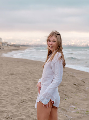 Luise Vivacious Blue-eyed Babe Stretches Out In The Warm Sand
