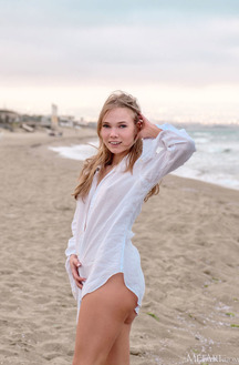 Luise Vivacious Blue-eyed Babe Stretches Out In The Warm Sand