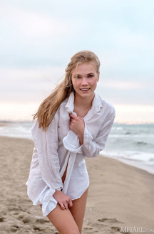 Luise Vivacious Blue-eyed Babe Stretches Out In The Warm Sand