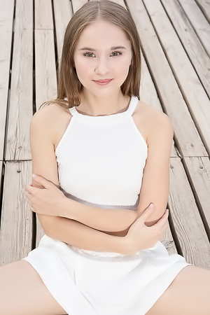 Sasha Quinn Smiling Playfully As Her Short Skirt Flips Up To Reveal She’s Not Wearing Panties